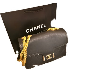 Chic handbag featuring a double chain handle and elegant CC design, perfect for stylish occasions.