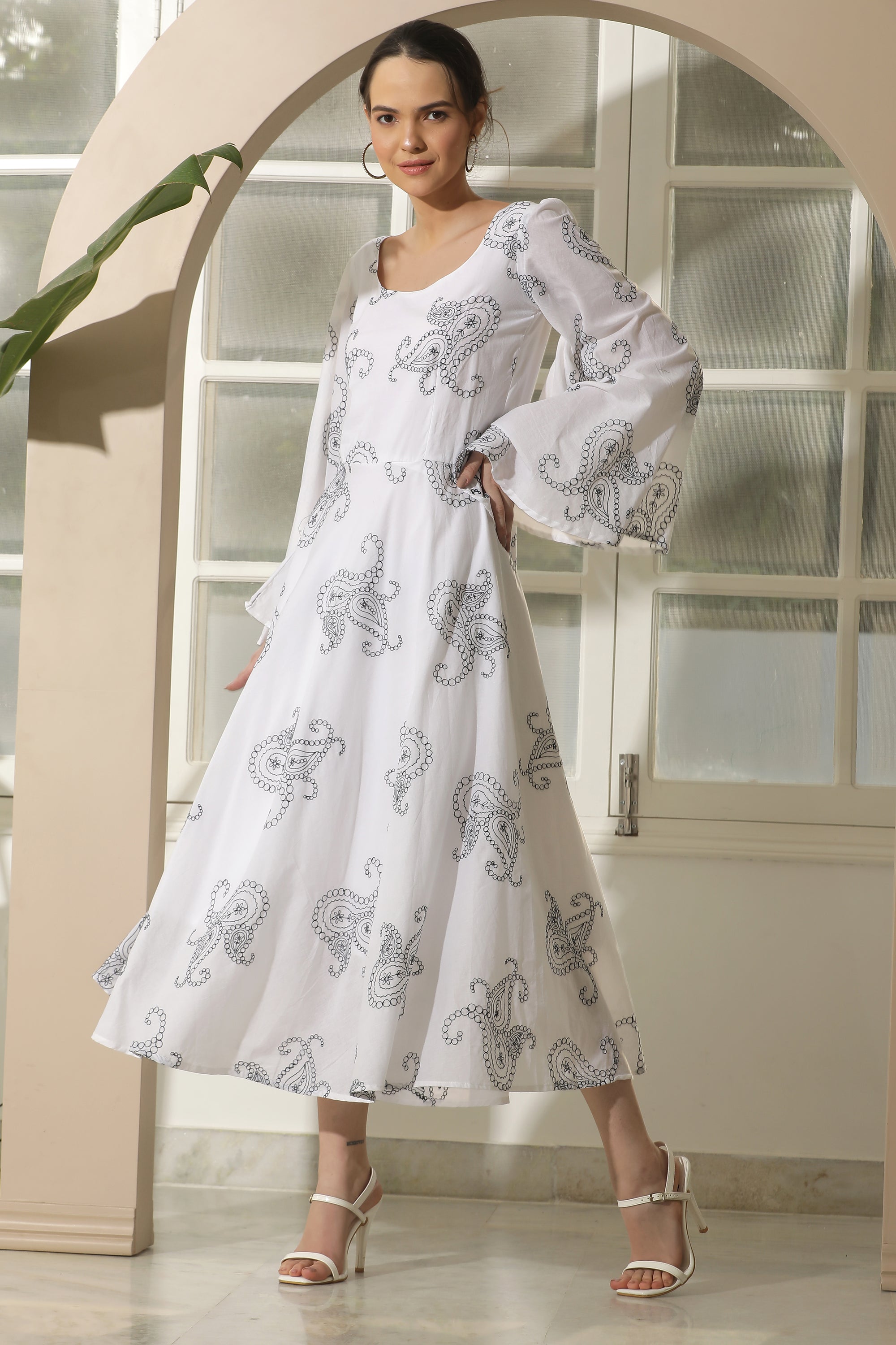 A stylish white flared dress featuring unique chicken embroidery and umbrella sleeves, perfect for casual occasions.
