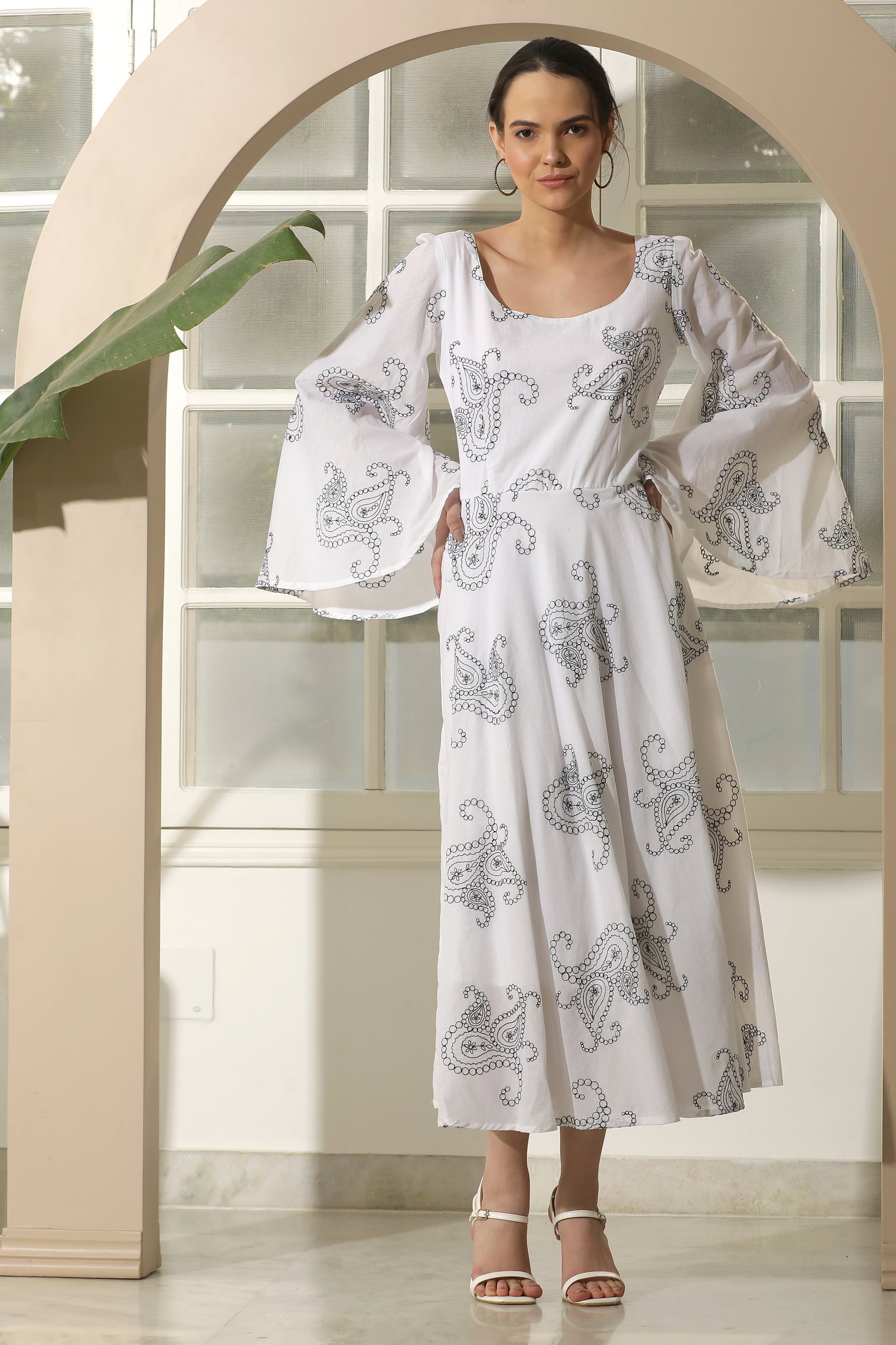 A stylish white flared dress featuring unique chicken embroidery and umbrella sleeves, perfect for casual occasions.