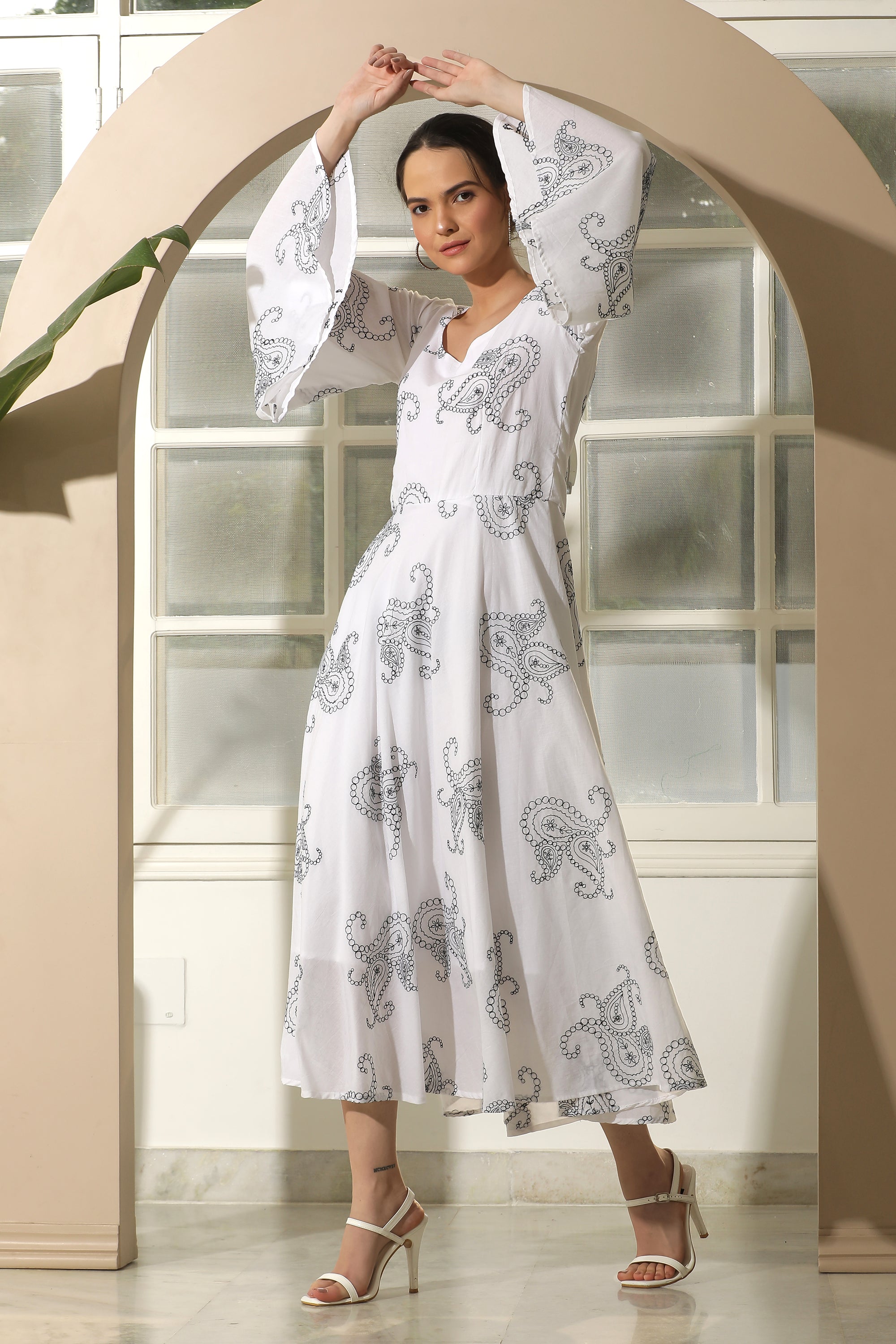 A stylish white flared dress featuring unique chicken embroidery and umbrella sleeves, perfect for casual occasions.