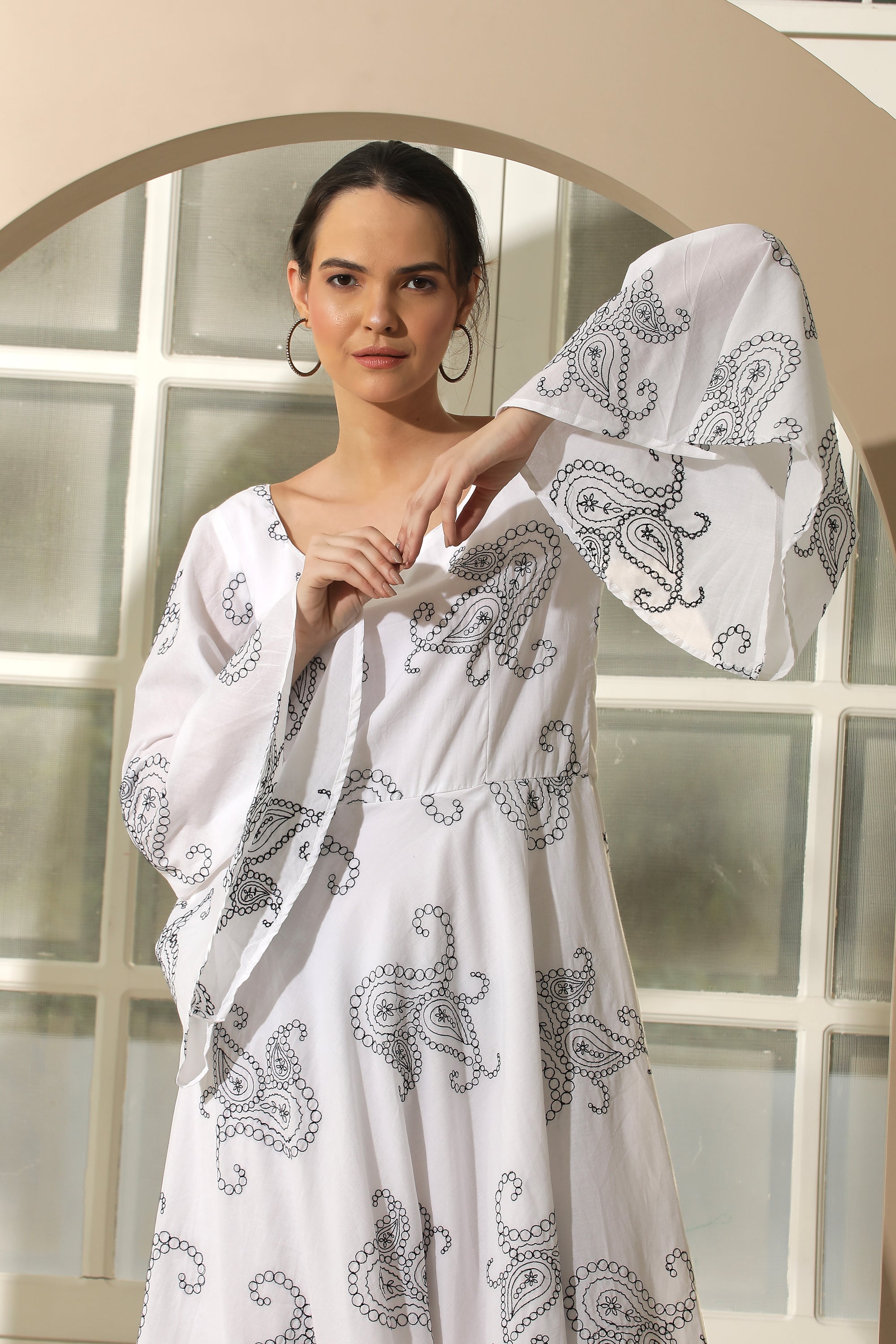 A stylish white flared dress featuring unique chicken embroidery and umbrella sleeves, perfect for casual occasions.