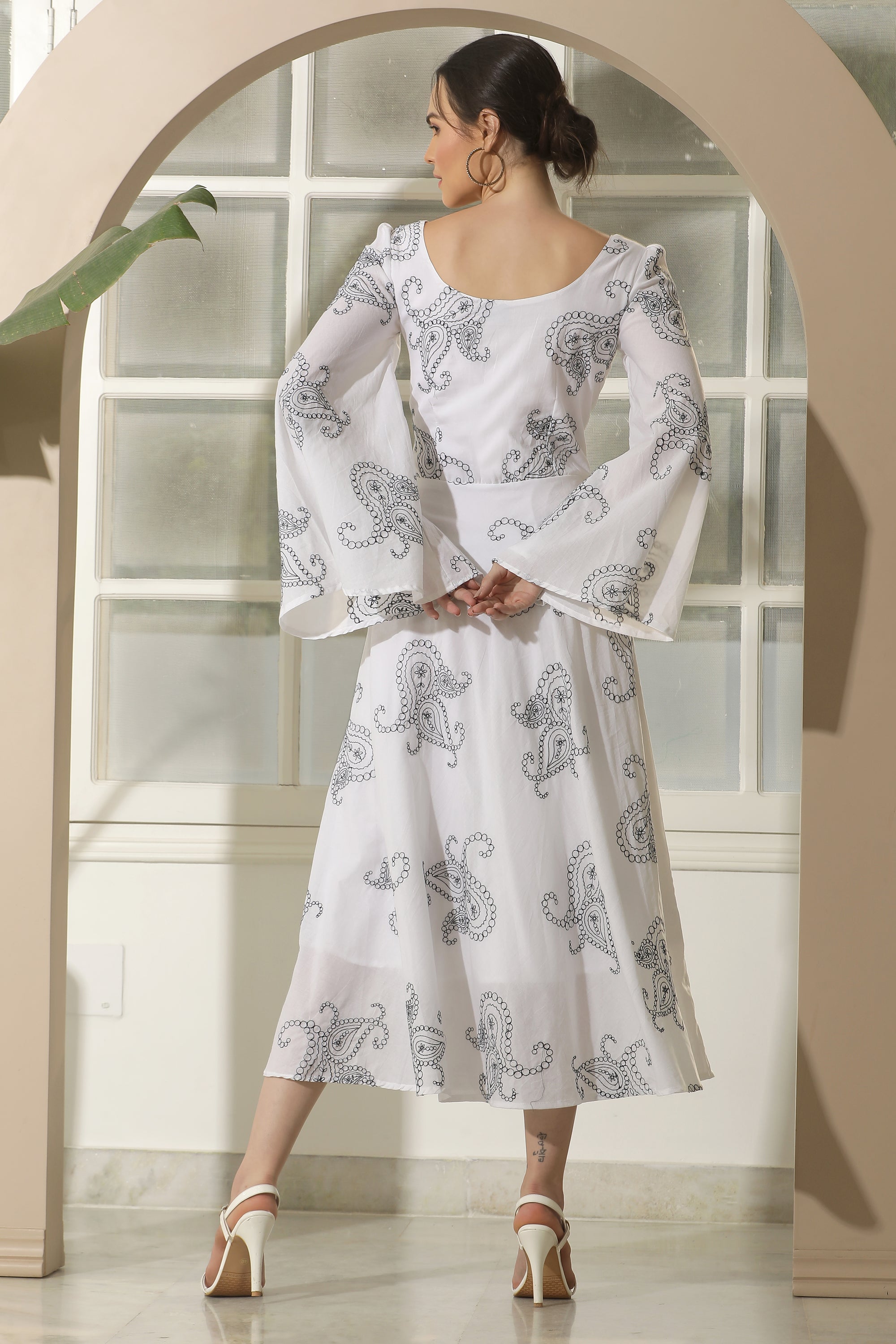 A stylish white flared dress featuring unique chicken embroidery and umbrella sleeves, perfect for casual occasions.