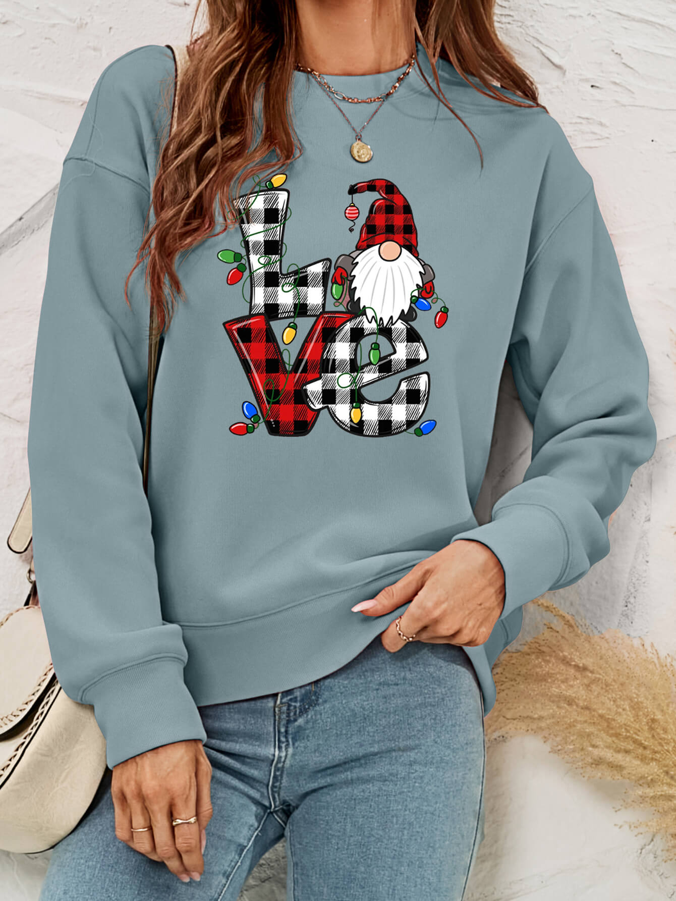 A cozy Christmas Plaid Graphic Dropped Shoulder Sweatshirt featuring a festive plaid design, long sleeves, and a relaxed fit.