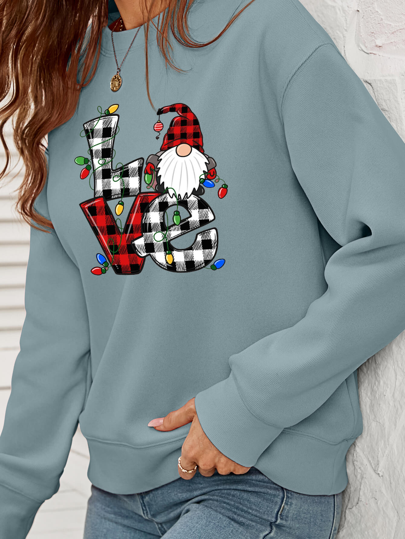 A cozy Christmas Plaid Graphic Dropped Shoulder Sweatshirt featuring a festive plaid design, long sleeves, and a relaxed fit.