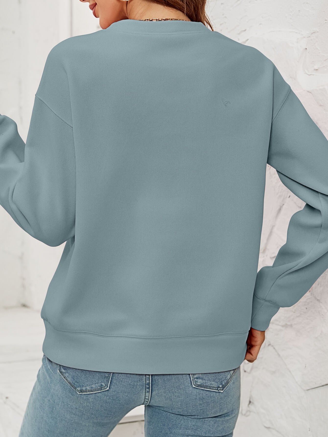 A cozy Christmas Plaid Graphic Dropped Shoulder Sweatshirt featuring a festive plaid design, long sleeves, and a relaxed fit.