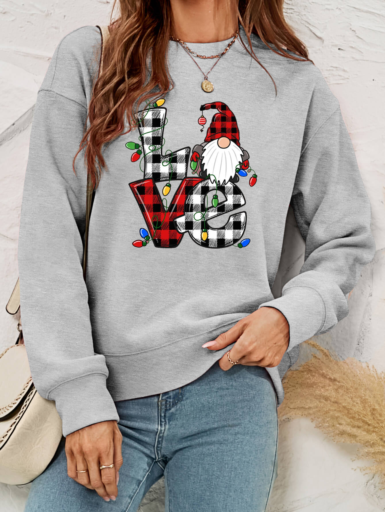 A cozy Christmas Plaid Graphic Dropped Shoulder Sweatshirt featuring a festive plaid design, long sleeves, and a relaxed fit.