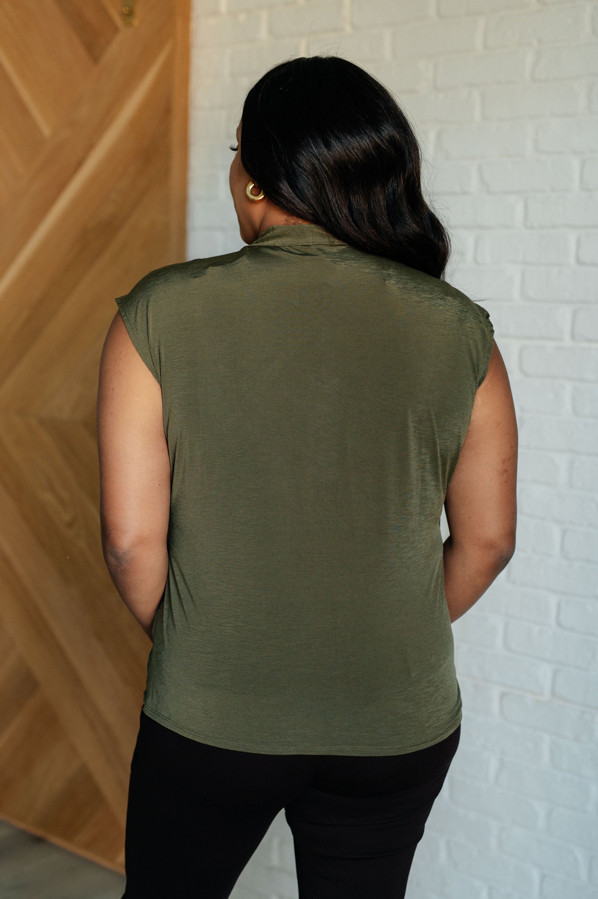 Classic Surplice Front Top in Olive featuring a chic neckline and asymmetrical hemline, made from high stretch Bulgari fabric.