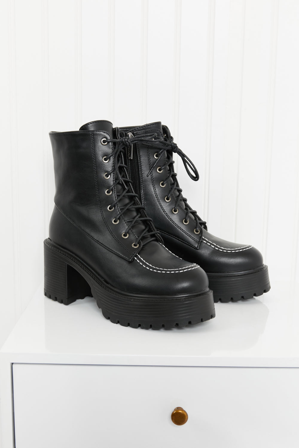 Climbing the Ranks Platform Combat Boots in Black featuring contrast stitching and chunky sole, showcasing stylish design and quality craftsmanship.