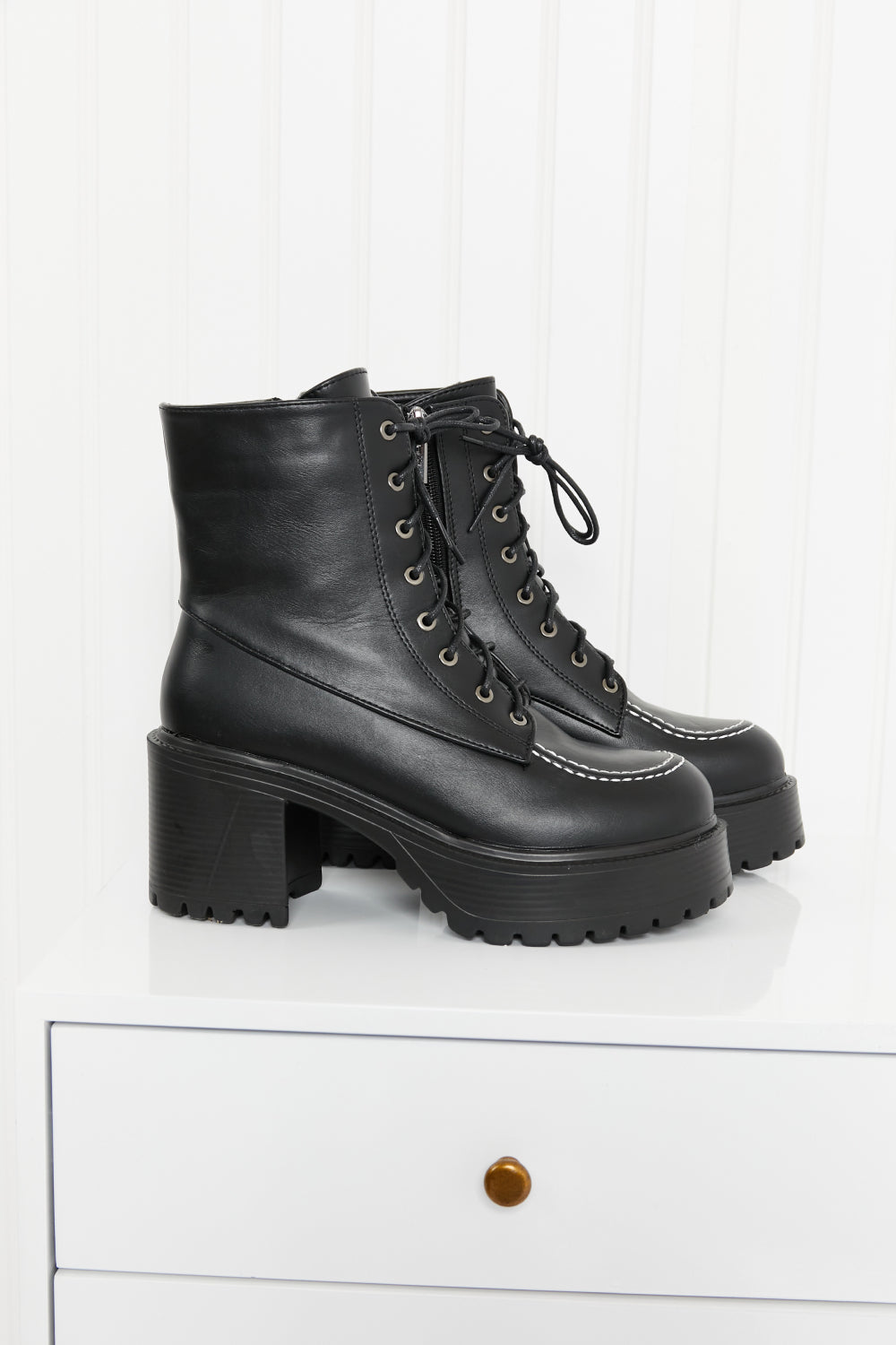 Climbing the Ranks Platform Combat Boots in Black featuring contrast stitching and chunky sole, showcasing stylish design and quality craftsmanship.