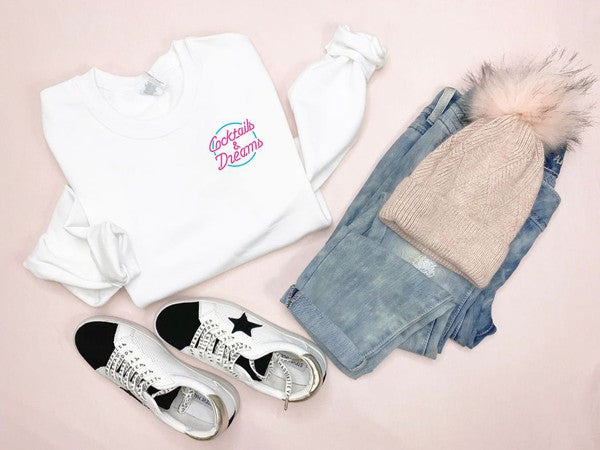 Cozy oversized crewneck sweatshirt featuring 'Cocktails and Dreams' embroidered on the left chest, made from soft fleece material.
