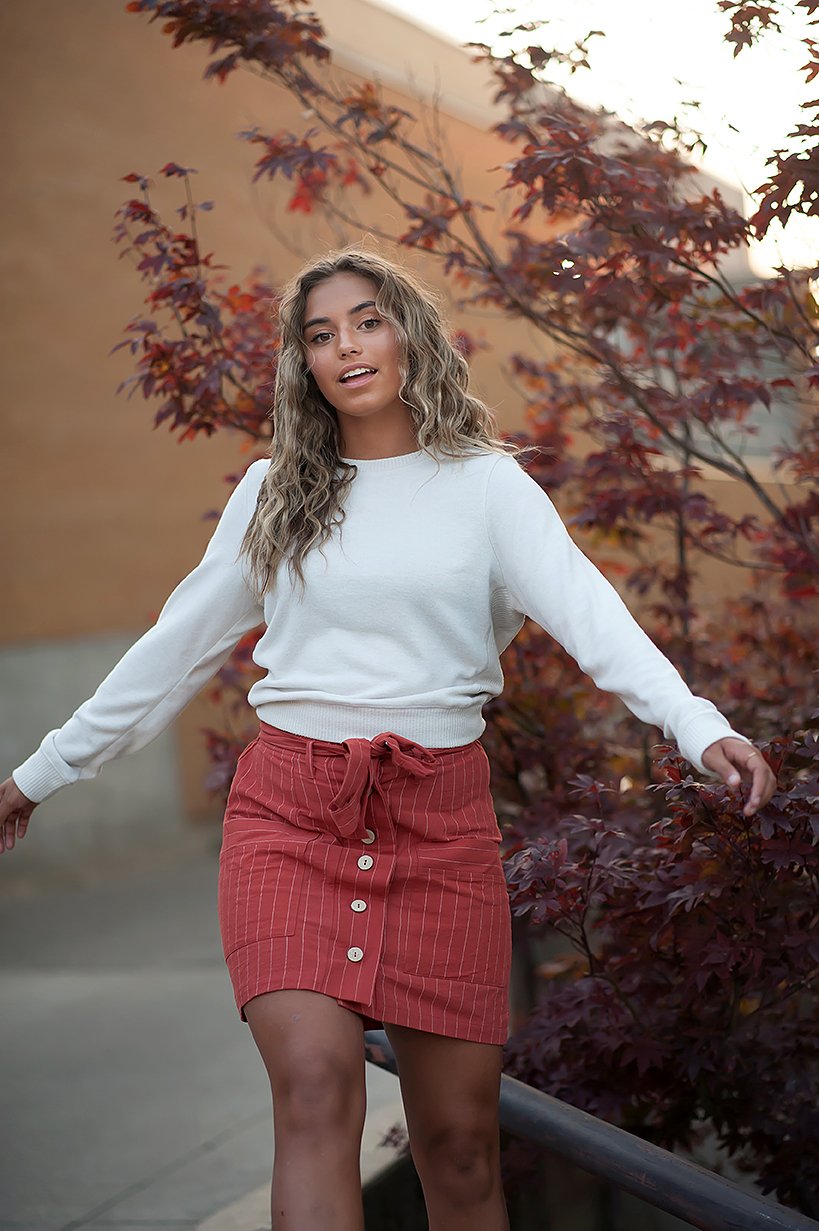 Coconut button stripe woven skirt in rust color with white stripes and a belt, featuring functional accent pockets.