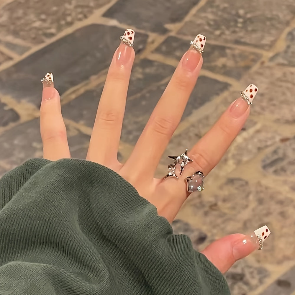 Coffin long fake nails with glitter and rhinestones, featuring a shimmery polka dot design, perfect for stylish manicures.