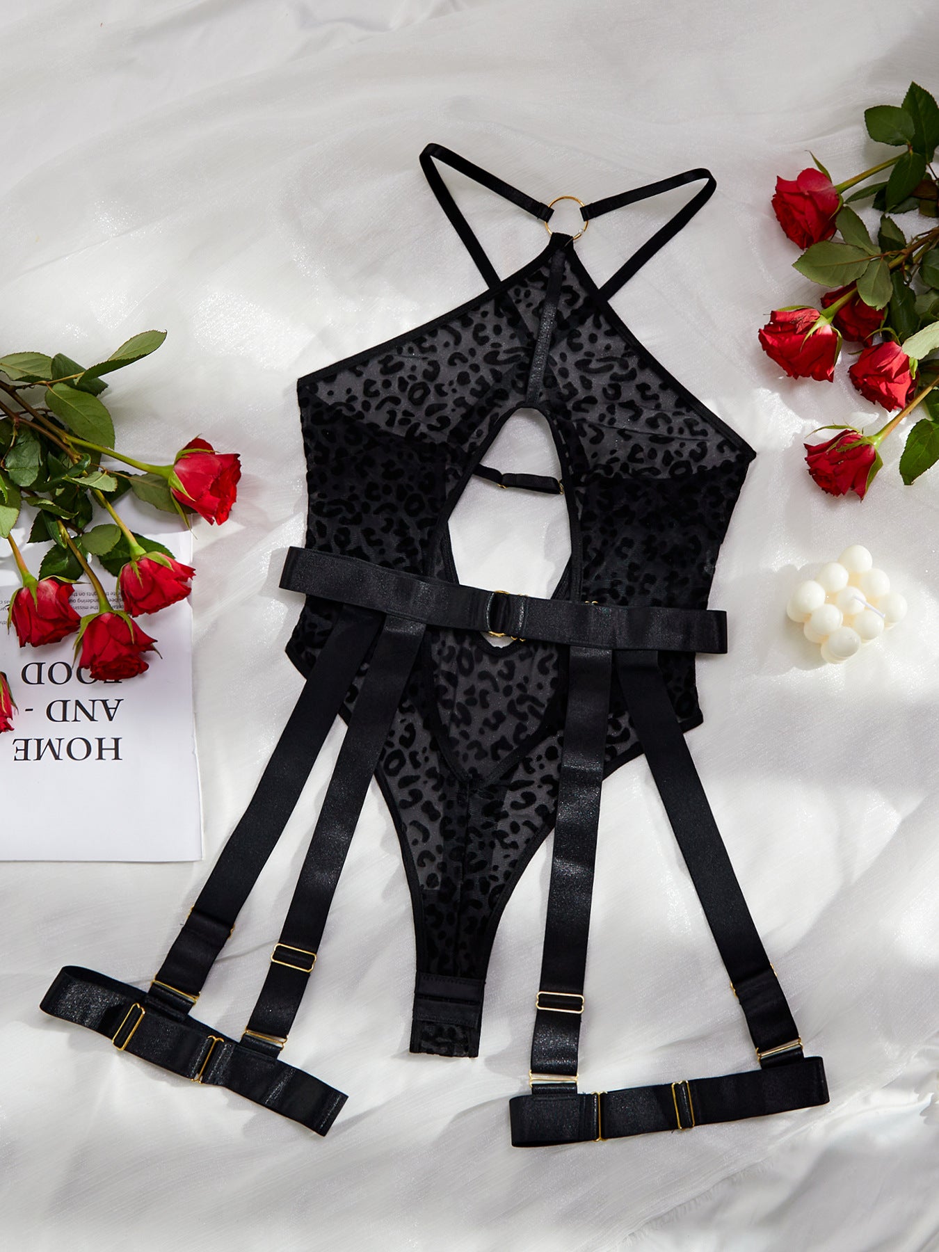 A stylish leopard print mesh bodysuit featuring sexy cutout designs and a cross backless style, perfect for enhancing allure.