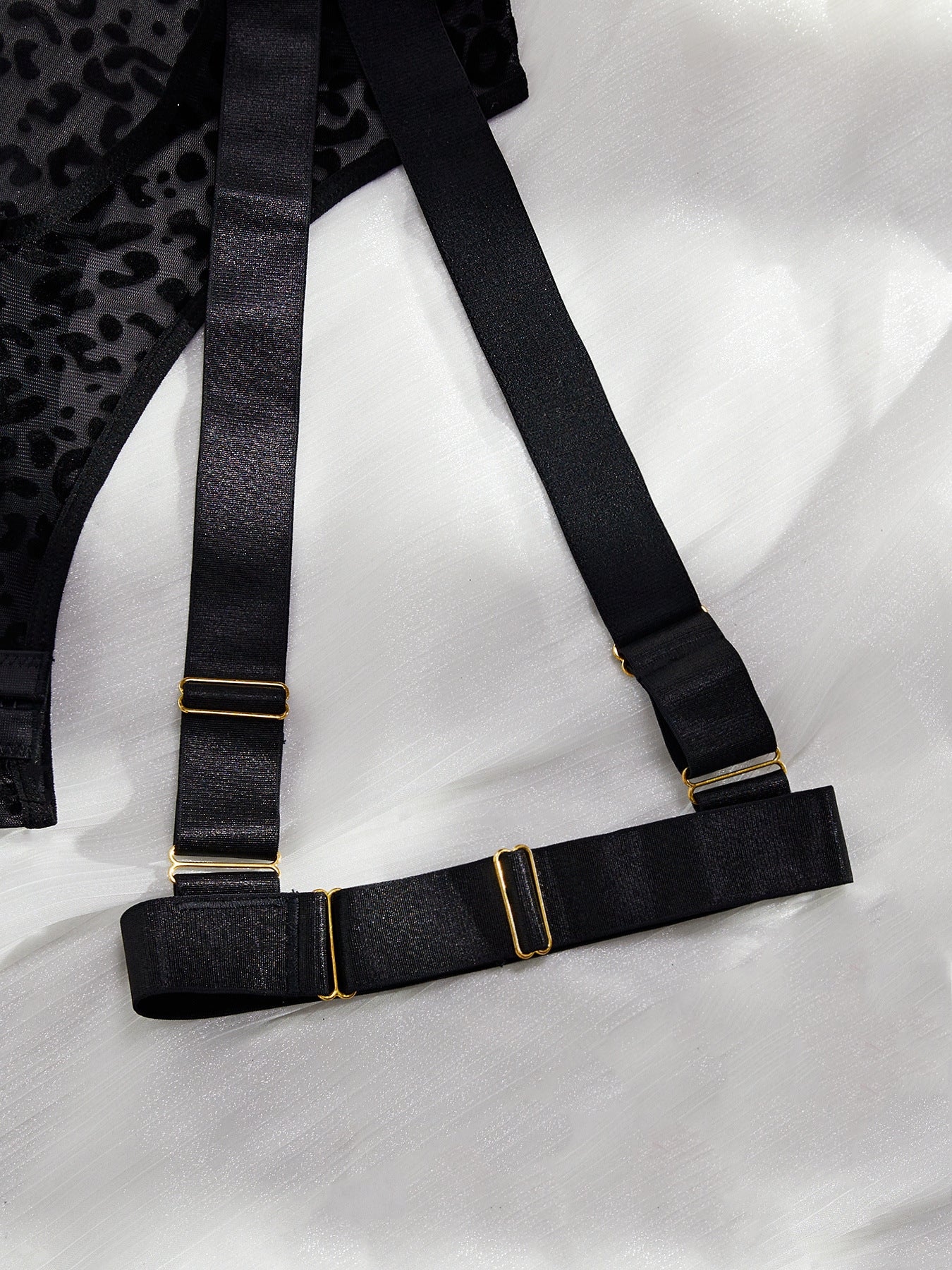 A stylish leopard print mesh bodysuit featuring sexy cutout designs and a cross backless style, perfect for enhancing allure.