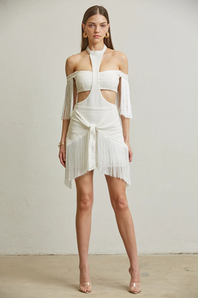 A stylish two-piece set featuring an off-shoulder crop top with fringed sleeves and a fringed tie-front wrap skirt, perfect for modern fashion.