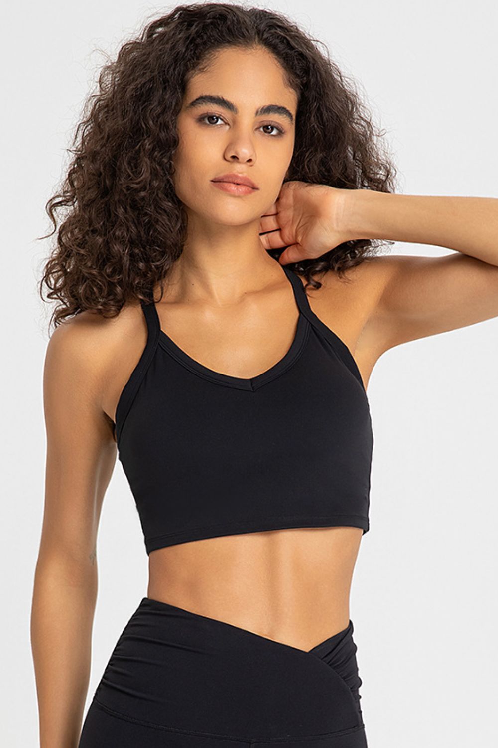 Crisscross Back V-Neck Sports Bra in solid color, featuring a stylish design and removable padding.