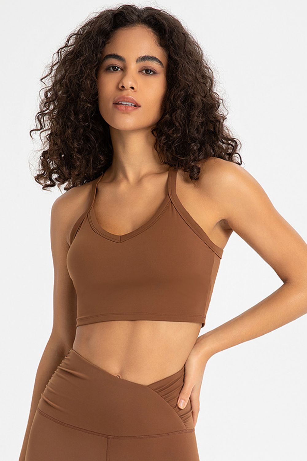 Crisscross Back V-Neck Sports Bra in solid color, featuring a stylish design and removable padding.