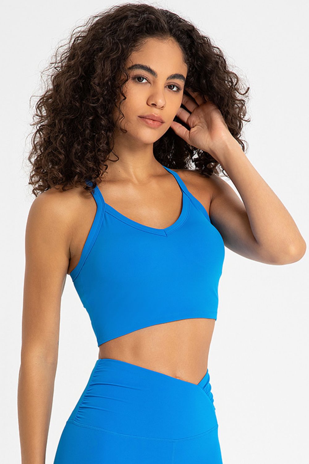 Crisscross Back V-Neck Sports Bra in solid color, featuring a stylish design and removable padding.