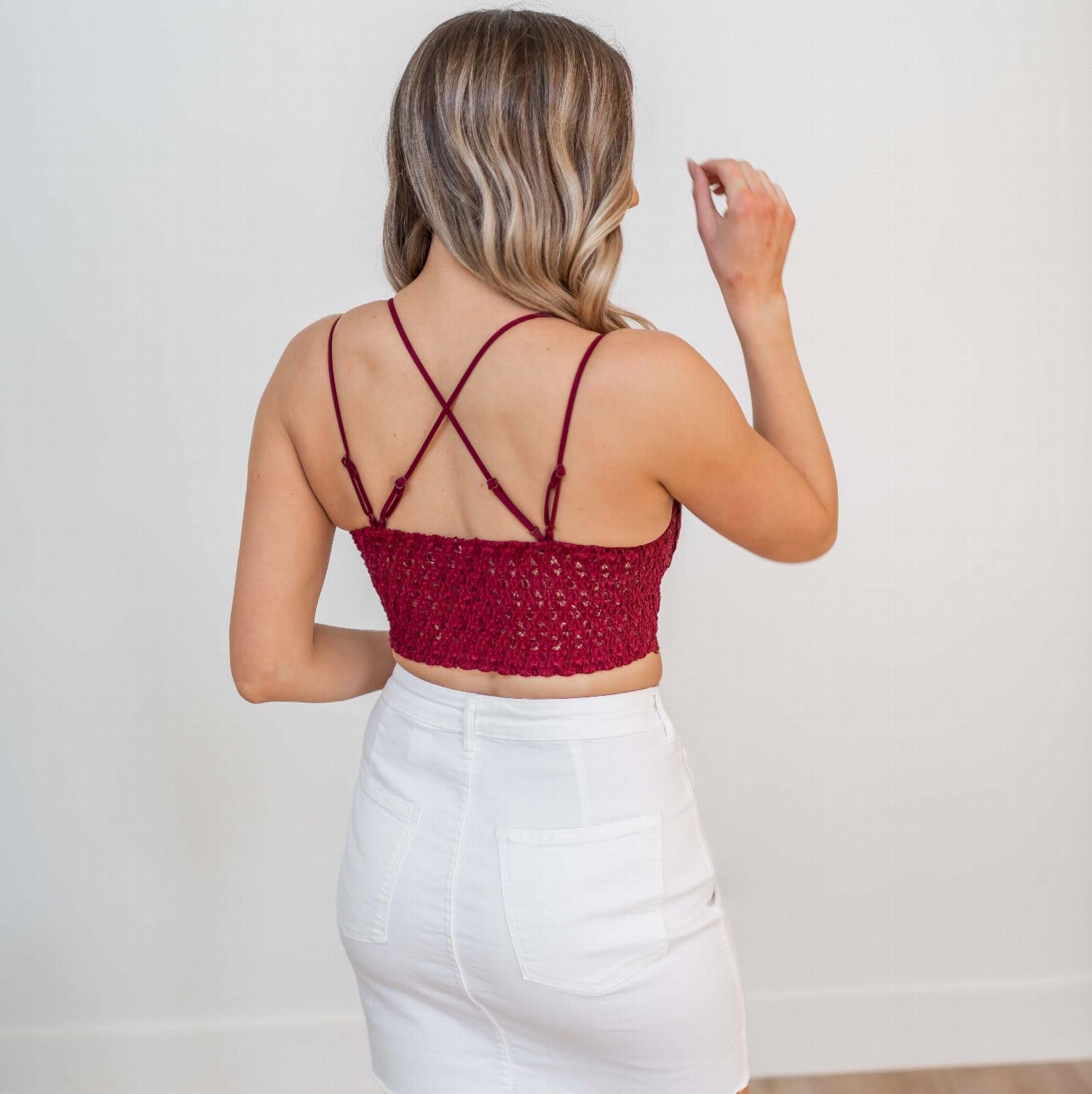 A stylish Crochet Lace Bralette with padded cups and dual shoulder straps, showcasing intricate lace detailing.