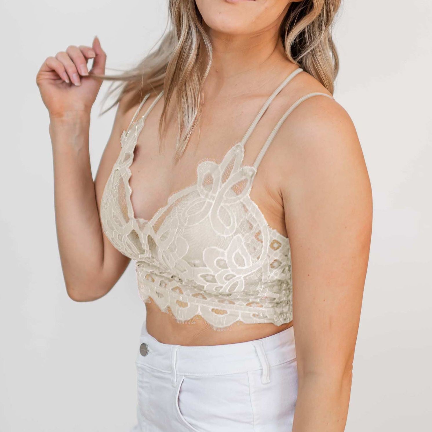 A stylish Crochet Lace Bralette with padded cups and dual shoulder straps, showcasing intricate lace detailing.