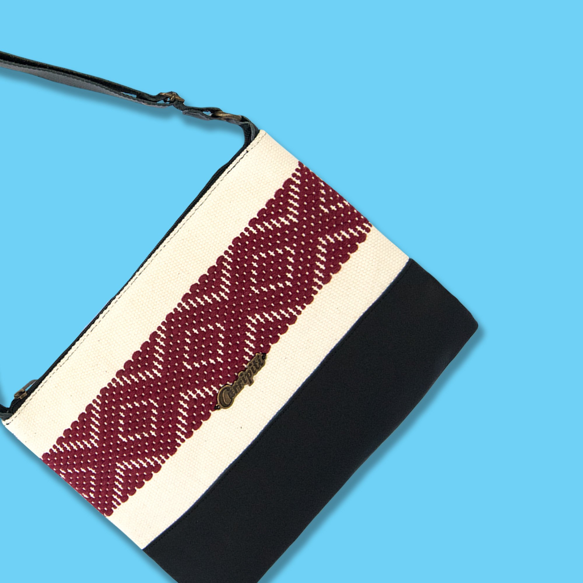 Elegant black leather cross-body bag featuring a burgundy stripe and geometric woven design, perfect for everyday use.