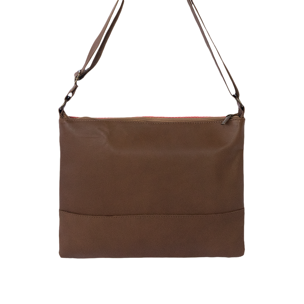 Brown leather cross-body bag featuring coral and green woven stripe, showcasing ethnic motifs and adjustable strap.