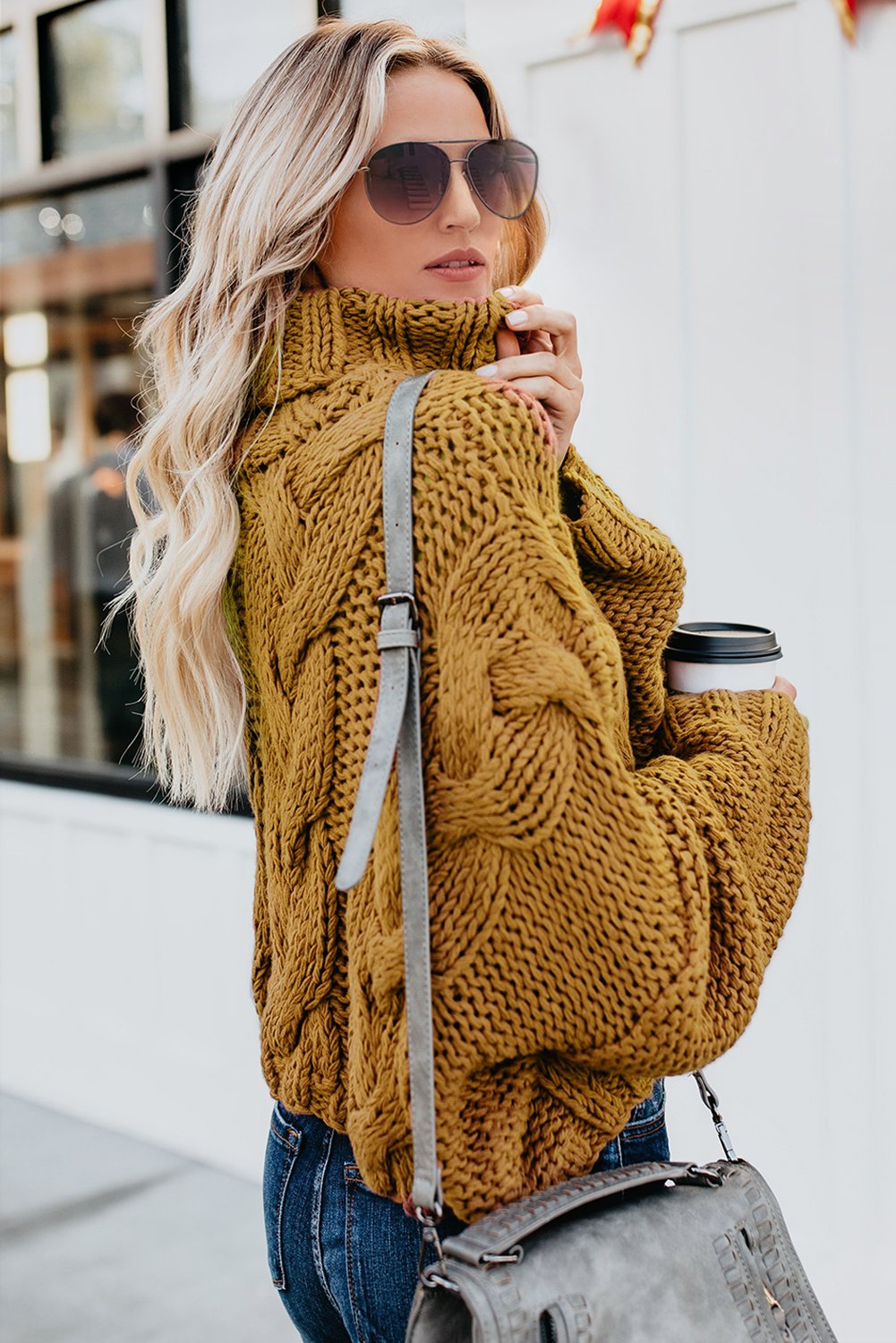 A cozy Cuddle Weather Cable Knit Handmade Turtleneck Sweater in a chunky knit design, featuring a warm turtleneck and oversized fit, perfect for winter wear.