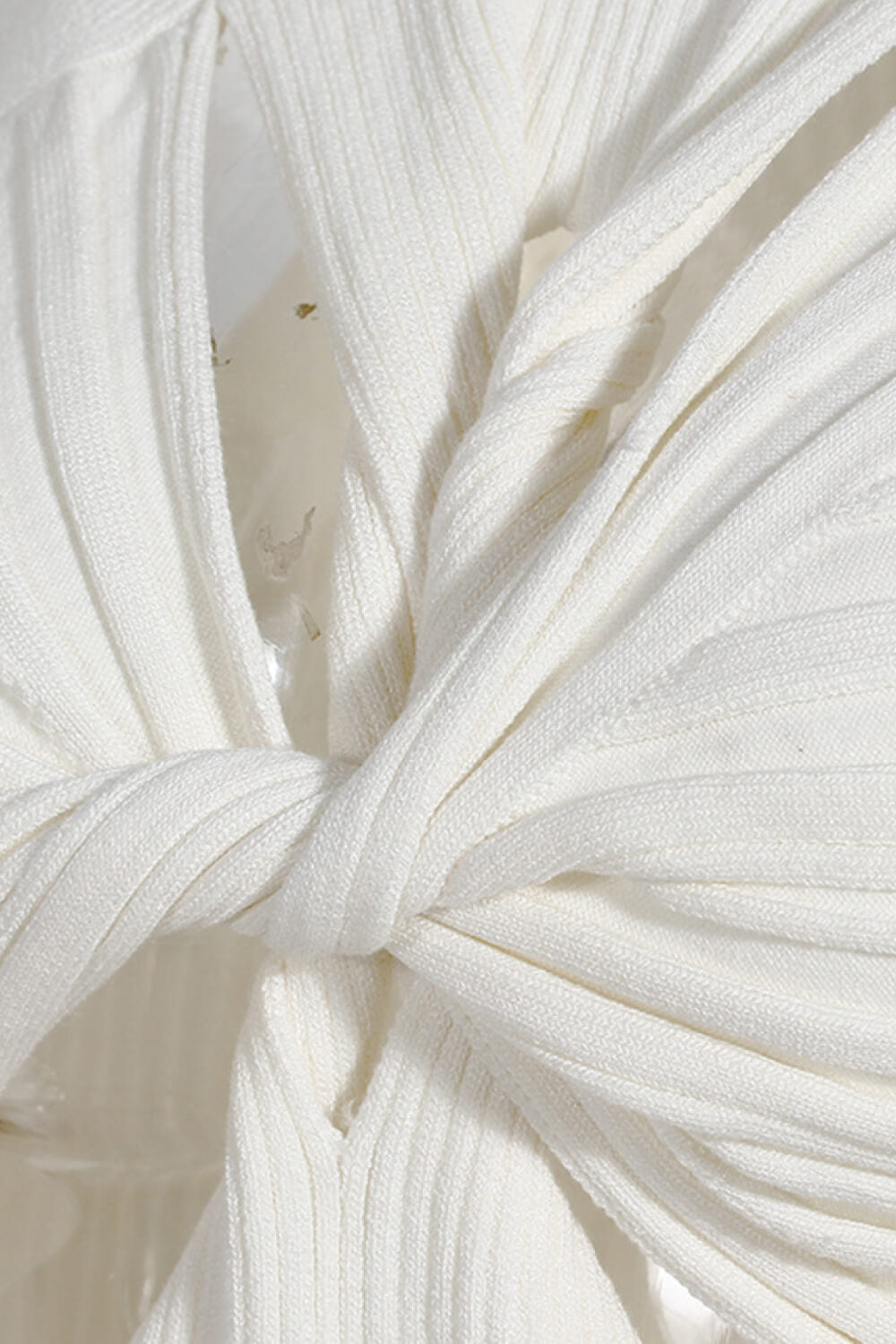 Cutout Twisted Front Sleeveless Sweater featuring a chic turtleneck and unique twisted front design, made from soft polyester.