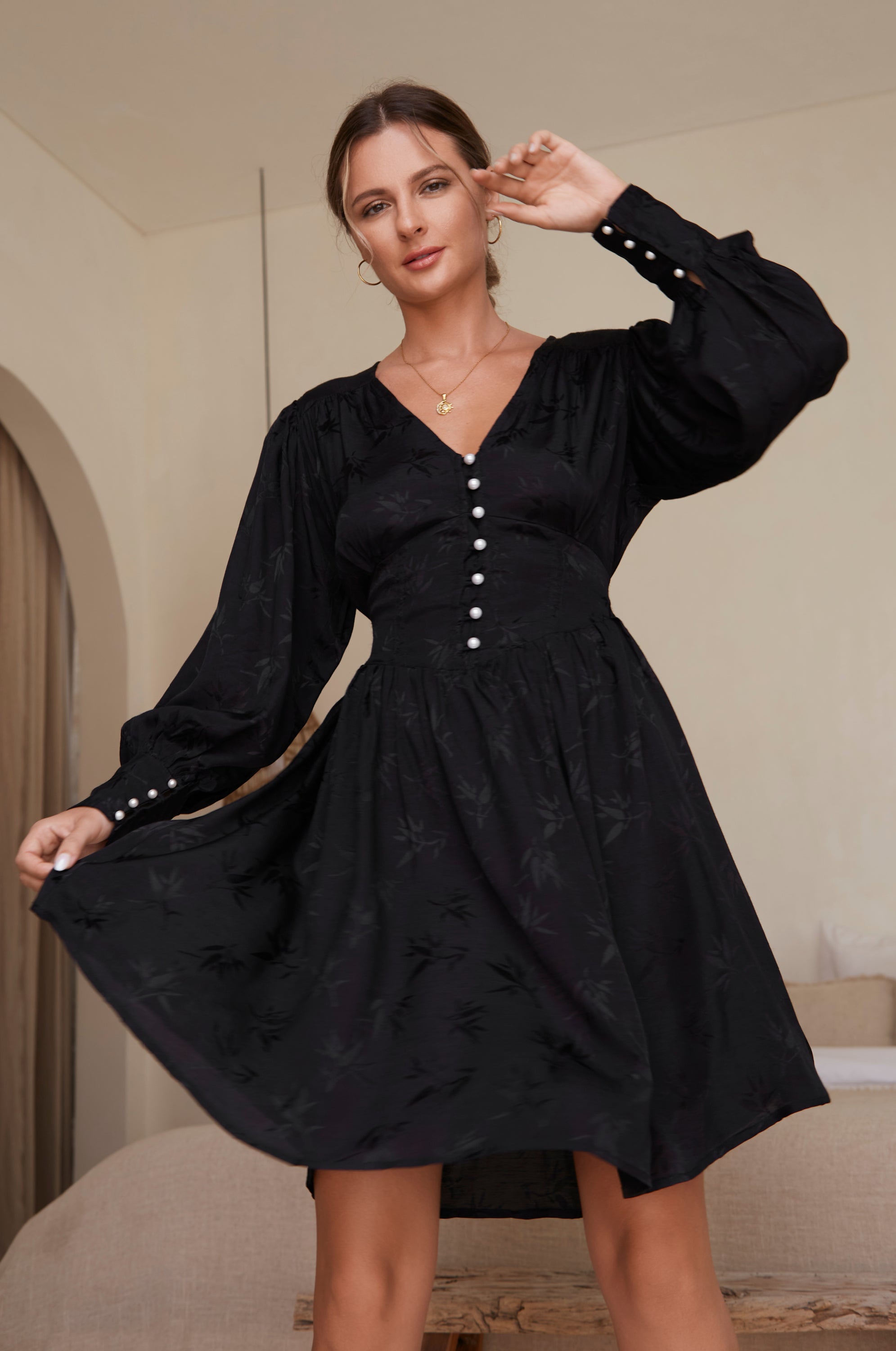 Daphne Floaty Long Sleeve Mini Dress featuring a romantic silhouette, smocked waist, voluminous sleeves, and pearl button details.