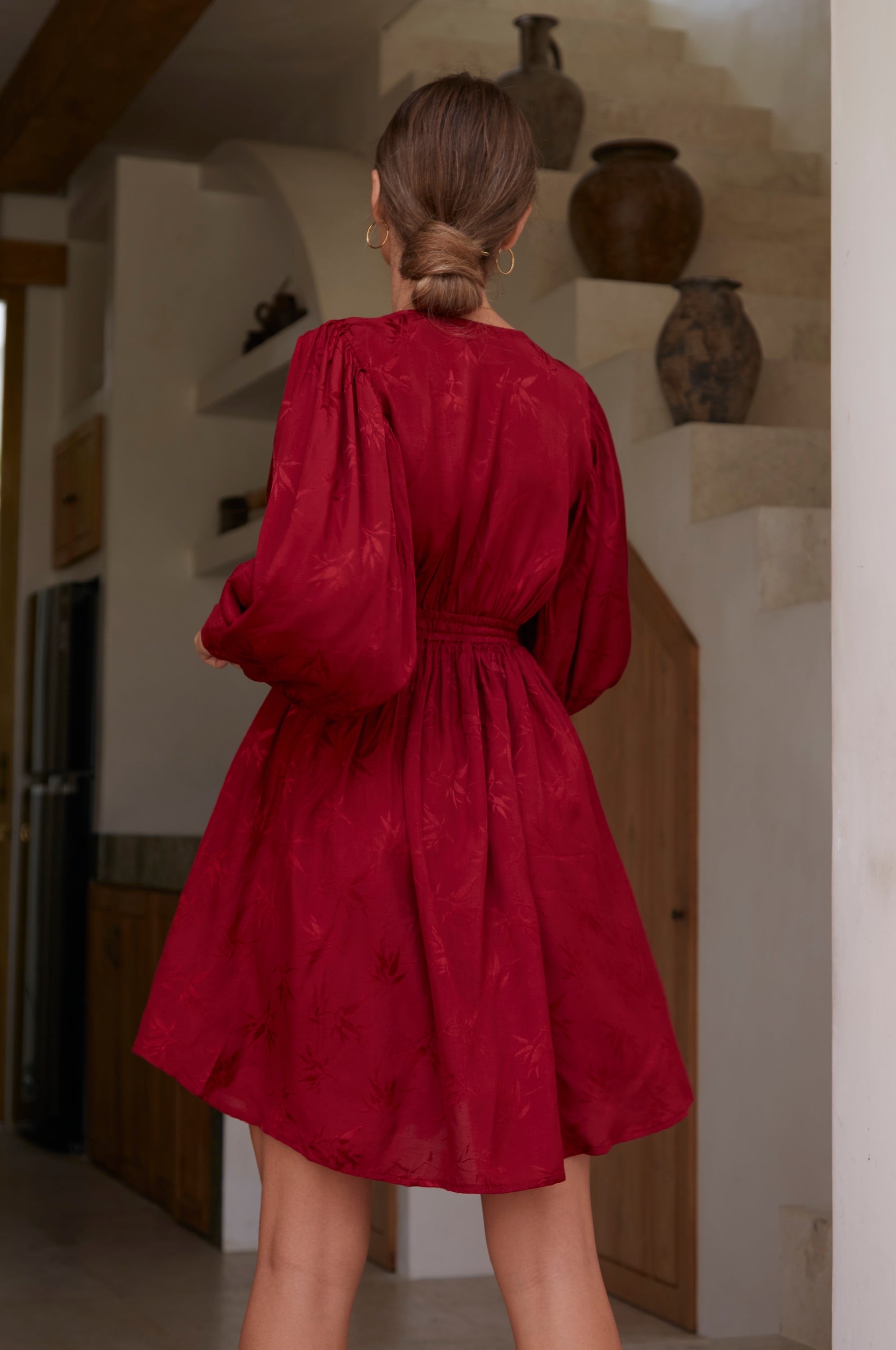 Daphne Floaty Long Sleeve Mini Dress featuring a romantic silhouette, smocked waist, voluminous sleeves, and pearl button details.