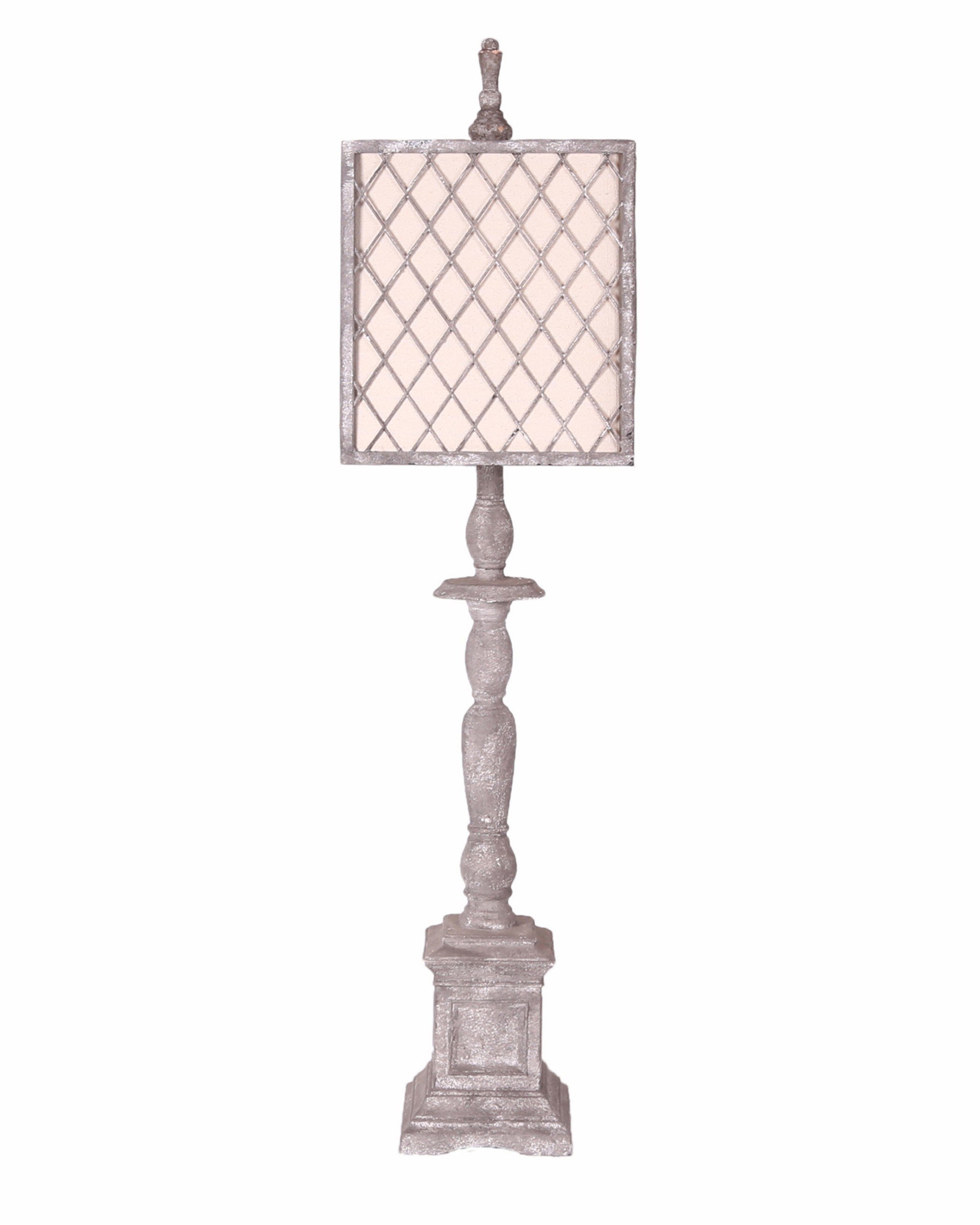 Distressed light grey traditional table lamp with ivory linen shade and mesh detailing, elegantly illuminating a stylish room.