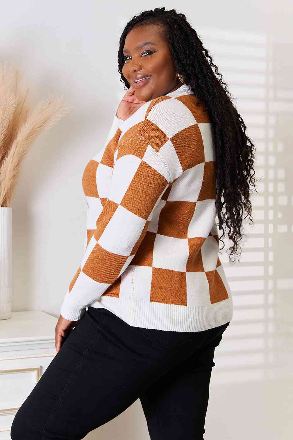 A stylish checkered button-up V-neck cardigan with dropped shoulders, showcasing its trendy design and cozy fit.