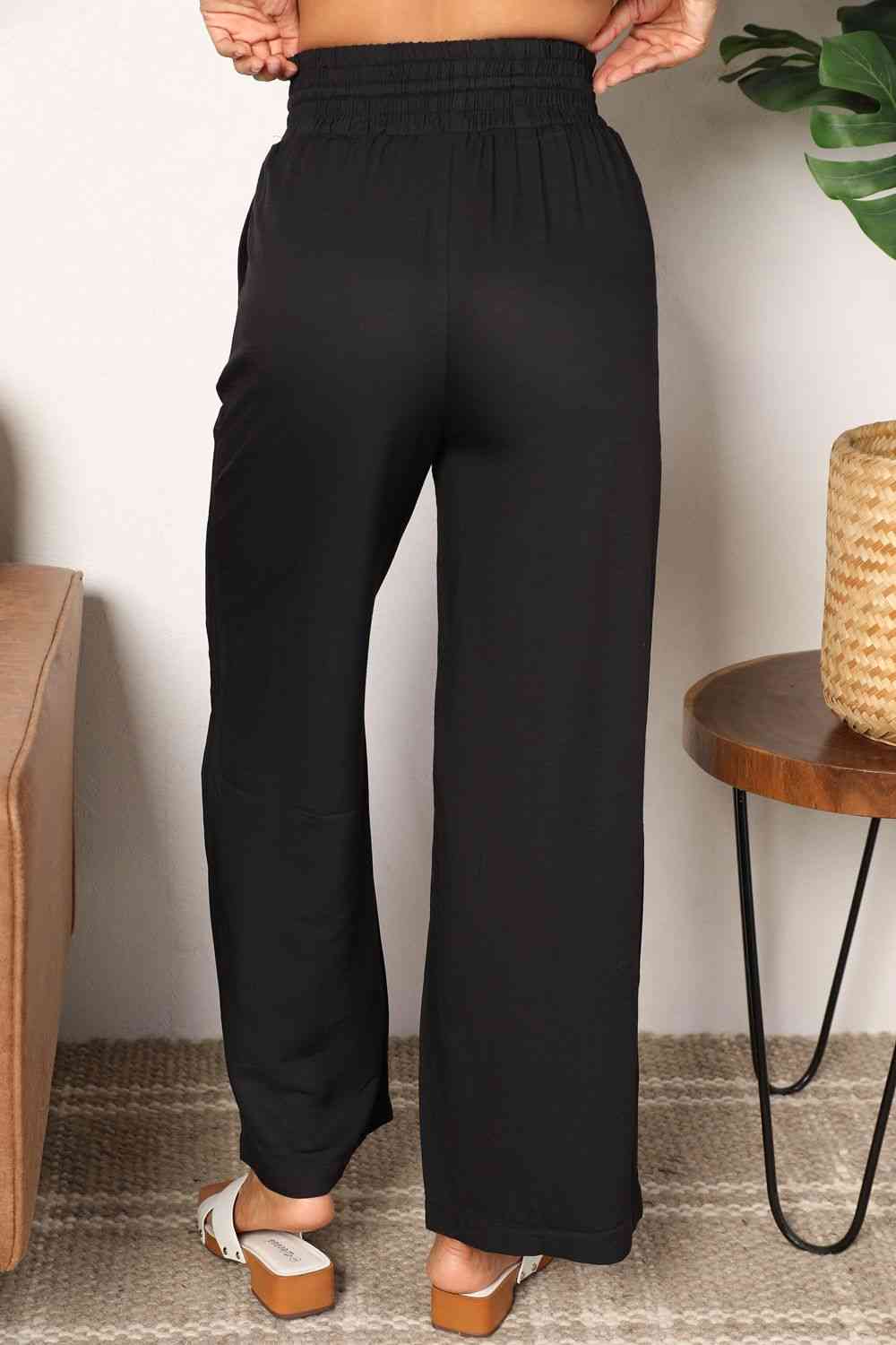 Double Take Drawstring Smocked Waist Wide Leg Pants in solid color, showcasing the drawstring waist and wide leg design.