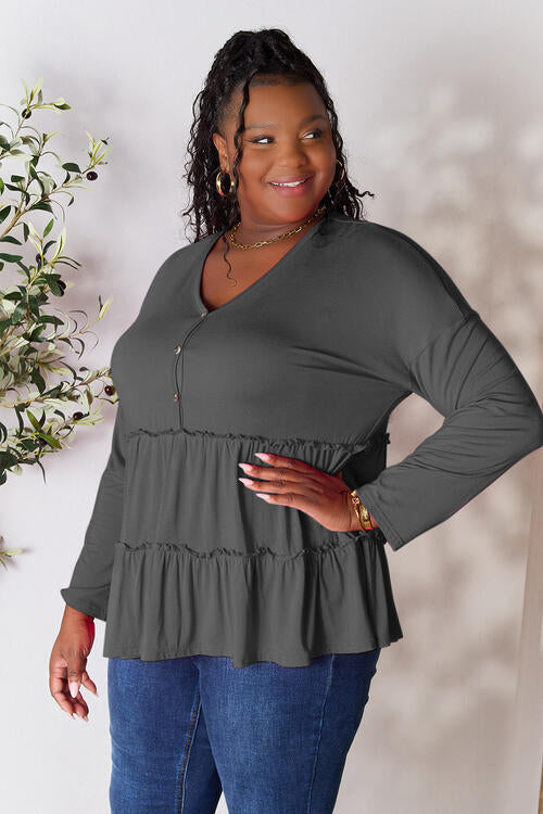 Double Take Half Button Long Sleeve Ruffle Hem Blouse in a stylish design with ruffle hem and half-button closure.