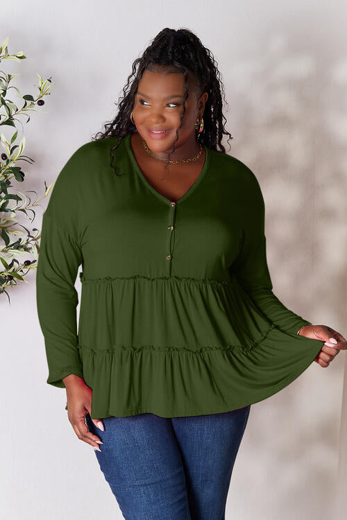 Double Take Half Button Long Sleeve Ruffle Hem Blouse in a stylish design with ruffle hem and half-button closure.