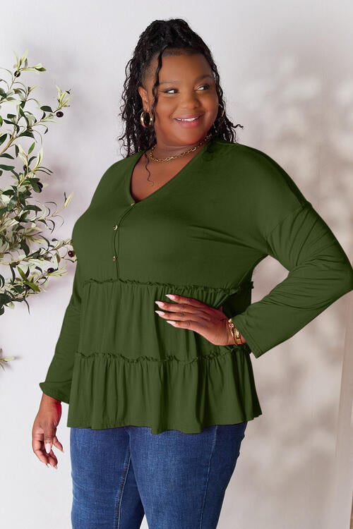 Double Take Half Button Long Sleeve Ruffle Hem Blouse in a stylish design with ruffle hem and half-button closure.