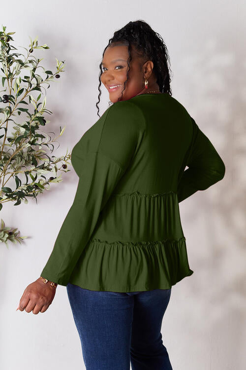 Double Take Half Button Long Sleeve Ruffle Hem Blouse in a stylish design with ruffle hem and half-button closure.