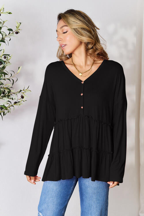 Double Take Half Button Long Sleeve Ruffle Hem Blouse in a stylish design with ruffle hem and half-button closure.