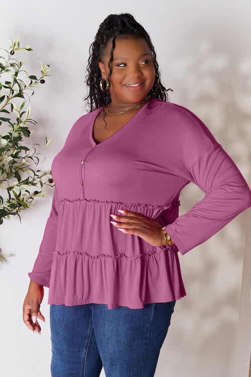 Double Take Half Button Long Sleeve Ruffle Hem Blouse in a stylish design with ruffle hem and half-button closure.