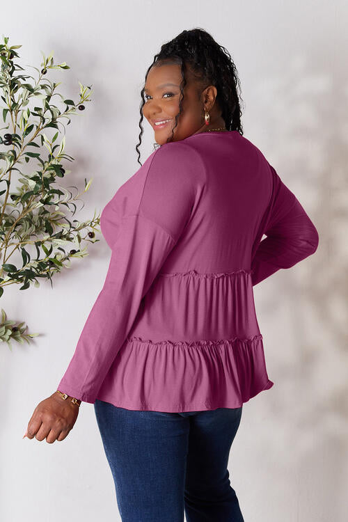 Double Take Half Button Long Sleeve Ruffle Hem Blouse in a stylish design with ruffle hem and half-button closure.