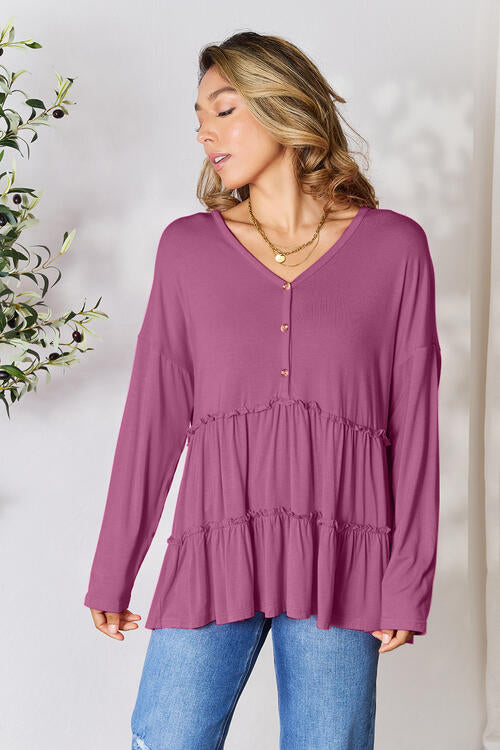 Double Take Half Button Long Sleeve Ruffle Hem Blouse in a stylish design with ruffle hem and half-button closure.