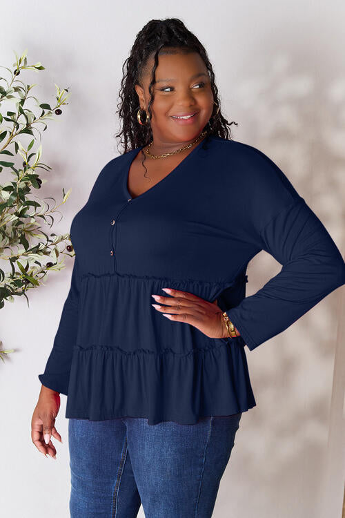 Double Take Half Button Long Sleeve Ruffle Hem Blouse in a stylish design with ruffle hem and half-button closure.