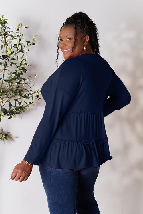 Double Take Half Button Long Sleeve Ruffle Hem Blouse in a stylish design with ruffle hem and half-button closure.