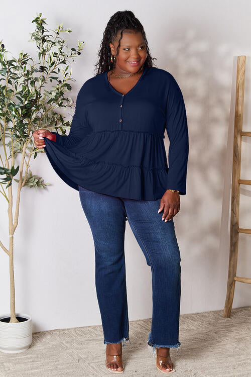 Double Take Half Button Long Sleeve Ruffle Hem Blouse in a stylish design with ruffle hem and half-button closure.