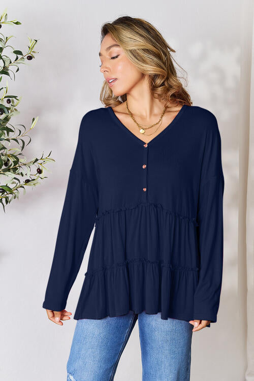 Double Take Half Button Long Sleeve Ruffle Hem Blouse in a stylish design with ruffle hem and half-button closure.