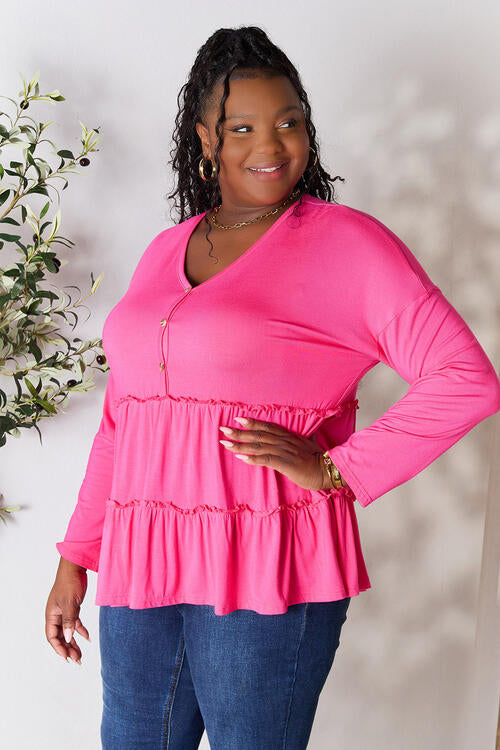 Double Take Half Button Long Sleeve Ruffle Hem Blouse in a stylish design with ruffle hem and half-button closure.