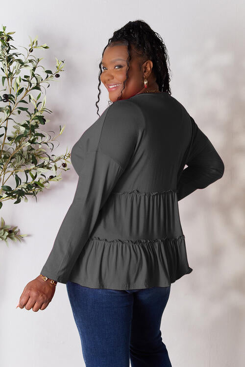 Double Take Half Button Long Sleeve Ruffle Hem Blouse in a stylish design with ruffle hem and half-button closure.