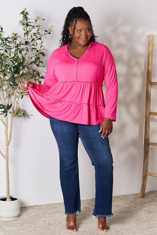 Double Take Half Button Long Sleeve Ruffle Hem Blouse in a stylish design with ruffle hem and half-button closure.