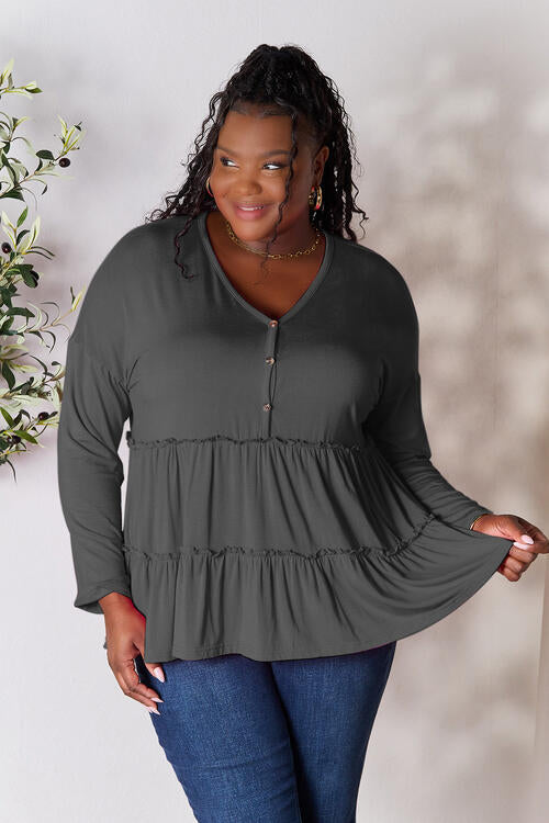 Double Take Half Button Long Sleeve Ruffle Hem Blouse in a stylish design with ruffle hem and half-button closure.
