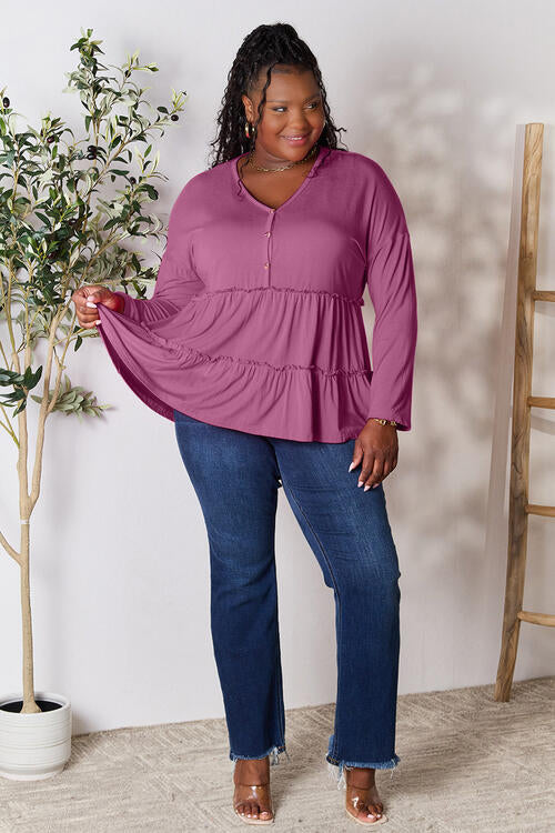 Double Take Half Button Long Sleeve Ruffle Hem Blouse in a stylish design with ruffle hem and half-button closure.